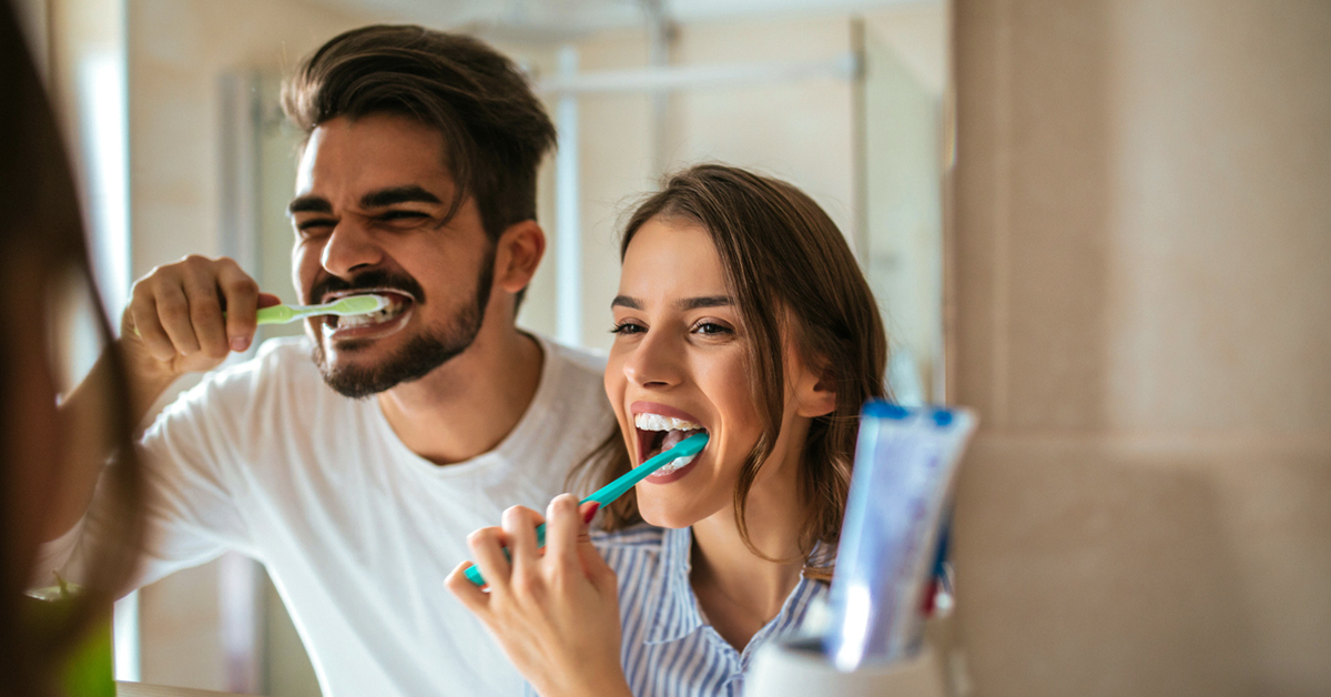 Couple brushing their teeth